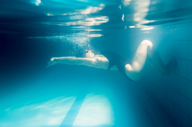 Fit woman swimming on back