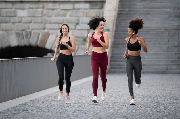 Fit women running together full shot