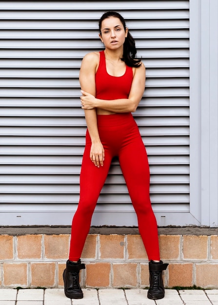 Fit young woman in sportswear posing