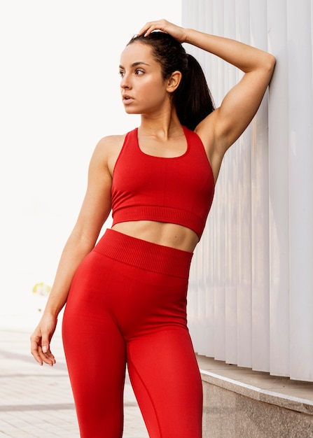 Fit young woman in sportswear posing