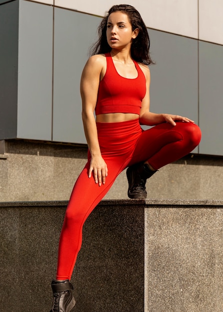 Fit young woman in sportswear posing