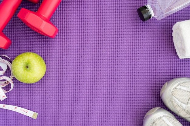 Free Photo | Fitness background with equipment over yoga mat