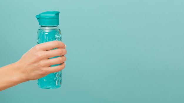 Fitness bottle filled with water copy space