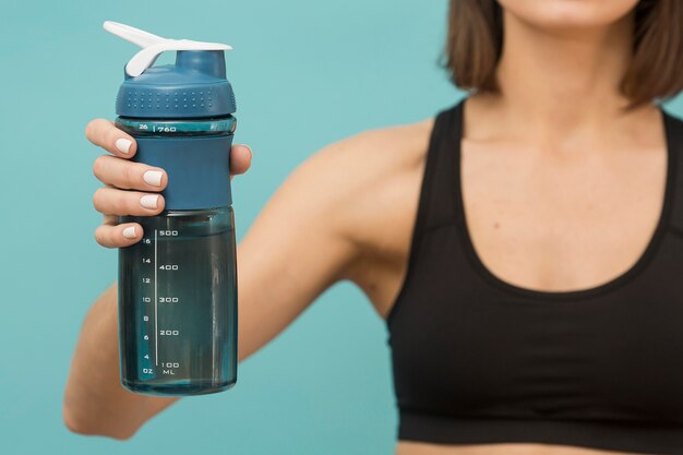 Fitness bottle filled with water and woman