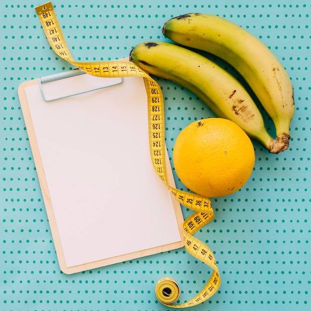 Fitness concept with clipboard and bananas