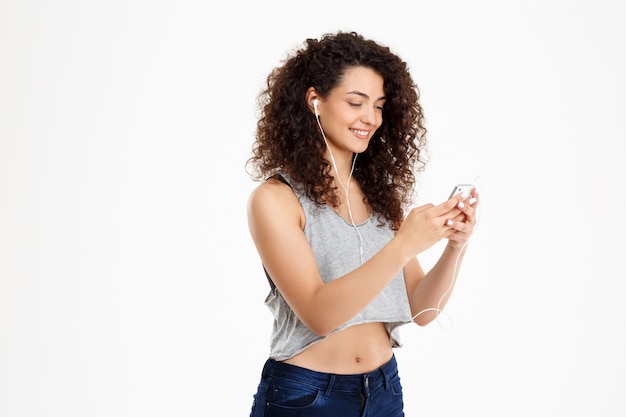 Fitness curly girl listening to music