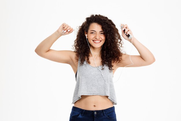 Fitness curly girl listening to music