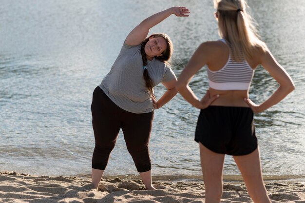 Fitness friends training on shore