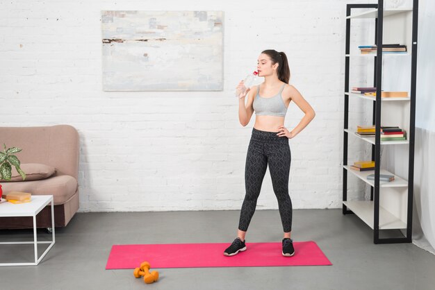 Fitness girl drinking water