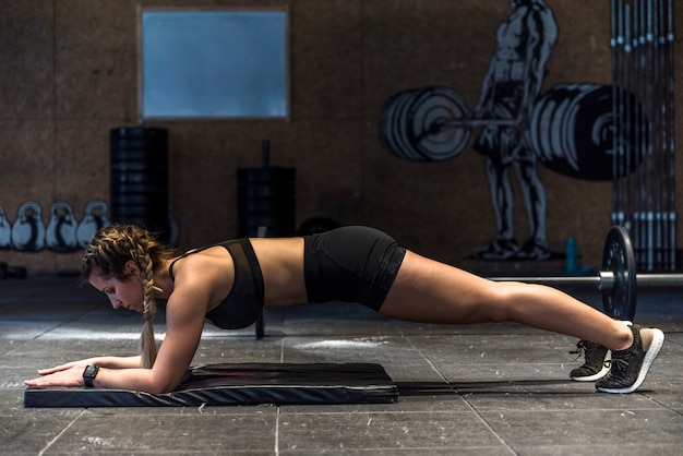 Fitness girl making flexing exercise