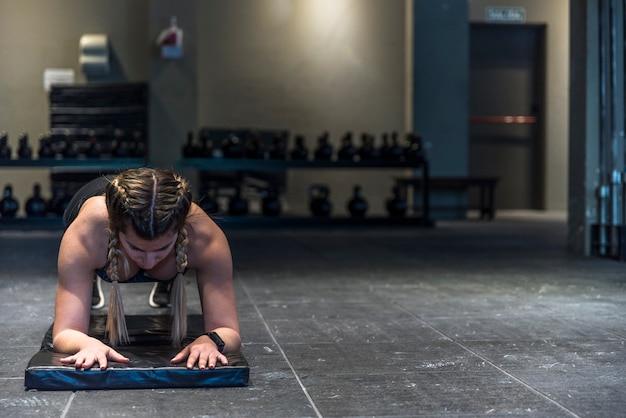 Fitness girl making flexing exercise