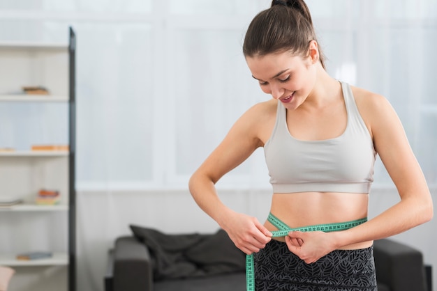 Fitness girl measuring herself