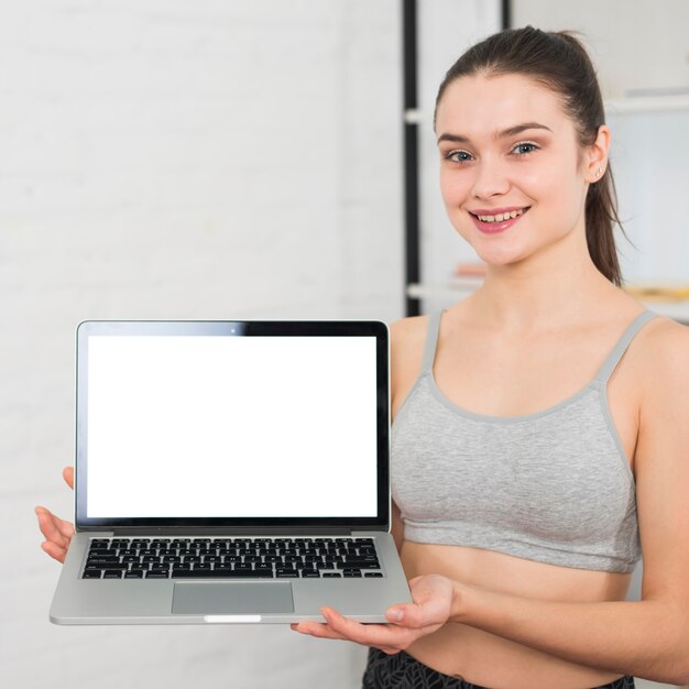 Fitness girl showing laptop