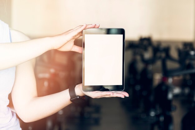 Fitness girl showing tablet