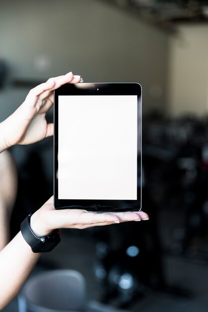 Fitness girl showing tablet