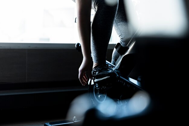 Fitness girl stationary bike detail