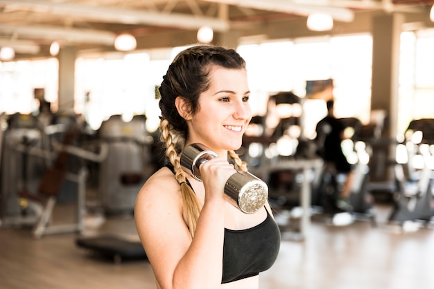 Fitness girl using dumbbell