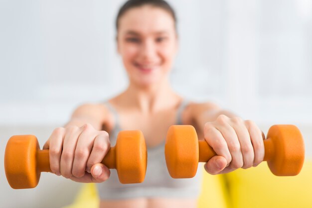 Fitness girl with dumbbells