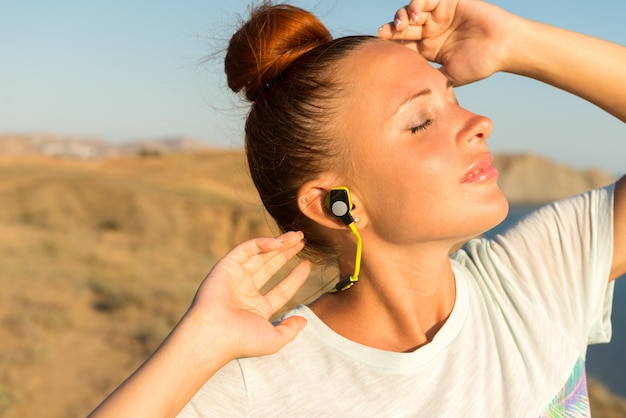 Fitness girl with wireless headphones