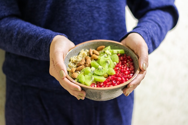 Fitness and healthy lifestyle concept. Female eating a healthy oatmeal after a workout.