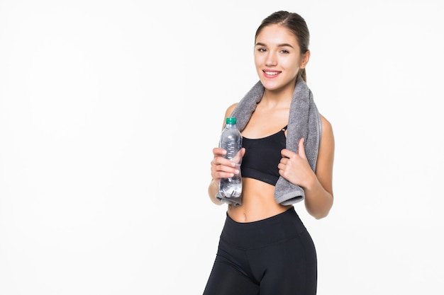 Fitness sporty muscular woman drinking water, isolated against white wall