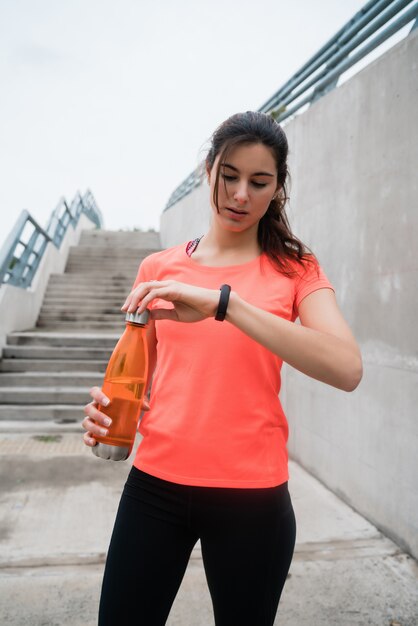 Fitness woman checking time on smart watch.