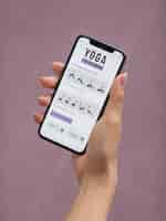 Free photo fitness woman doing yoga with a mobile app