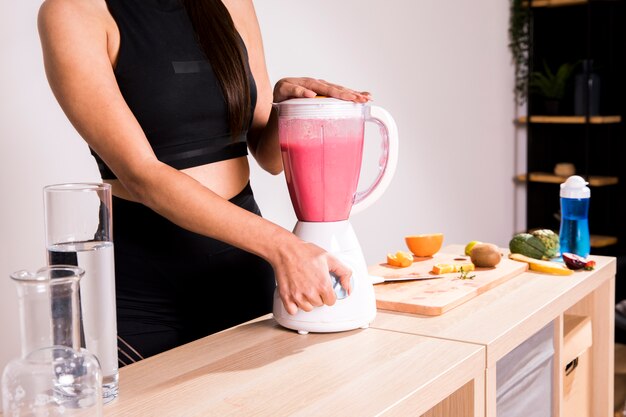 Fitness woman preparing a detox juice