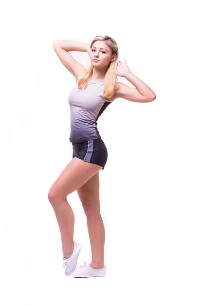 Fitness woman in sport style standing against white background. isolated