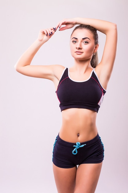 Fitness woman. Young sporty Caucasian female model isolated on white background in full body