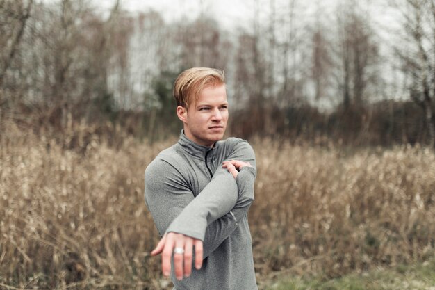 Fitness young man exercising in the field