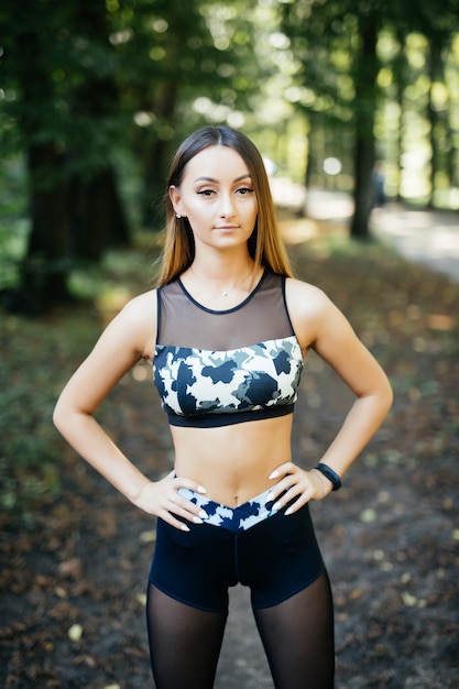 Fitness young woman walks in the park