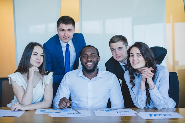 Five business people looking at the camera