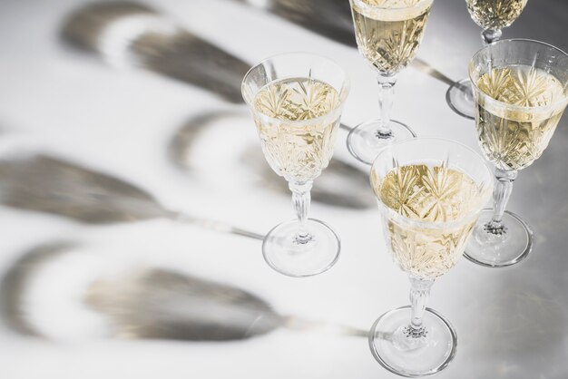 Five champagne glasses with shadows