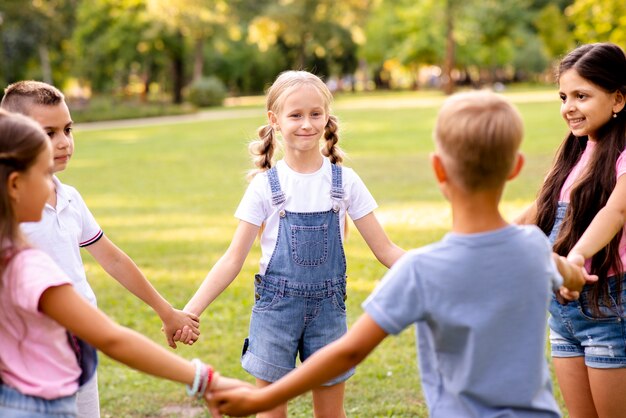 Five children forming a circle together