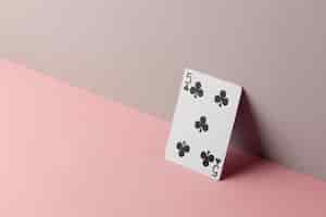 Free photo five of clubs on pink background