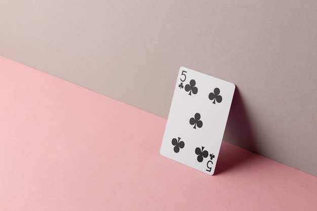 Five of clubs on pink background