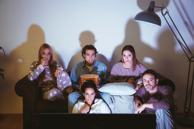 Five young friends watching a movie