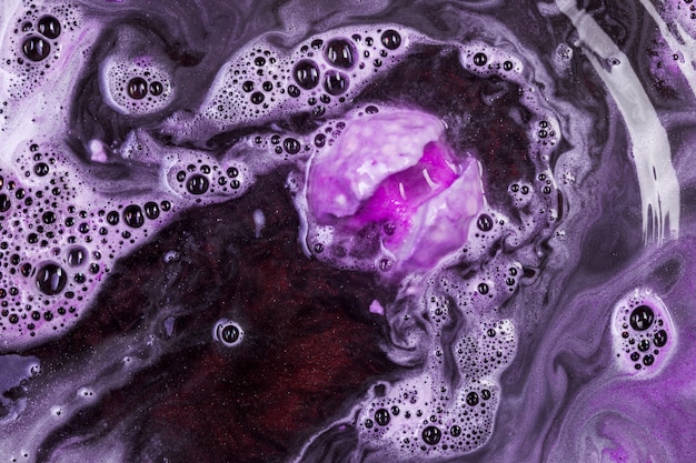 Fizzy purple bath bomb in water