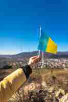 Free photo flag of ukraine in female hands against the sky