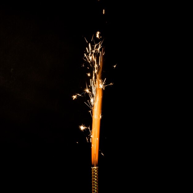 Flame with sparkles on black background