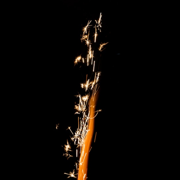 Flame with sparkles on black background