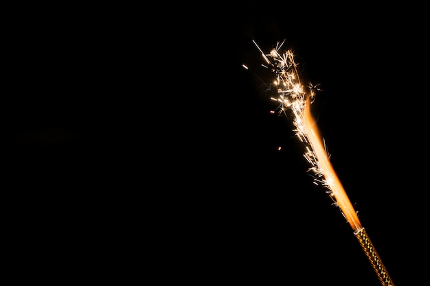 Flame with sparks on black background