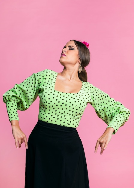 Free photo flamenco dancer with eyes closed with pink background