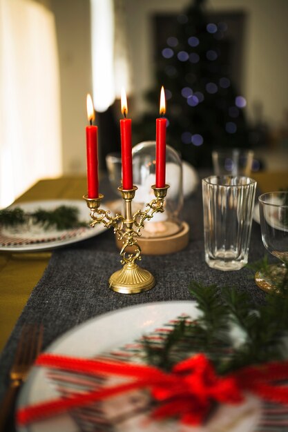 Flaming candles in candlestick on table 