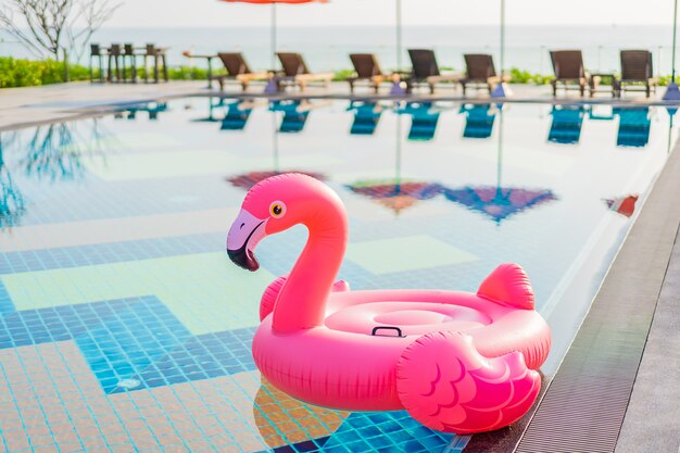 Flamingo float around swimming pool in hotel resort