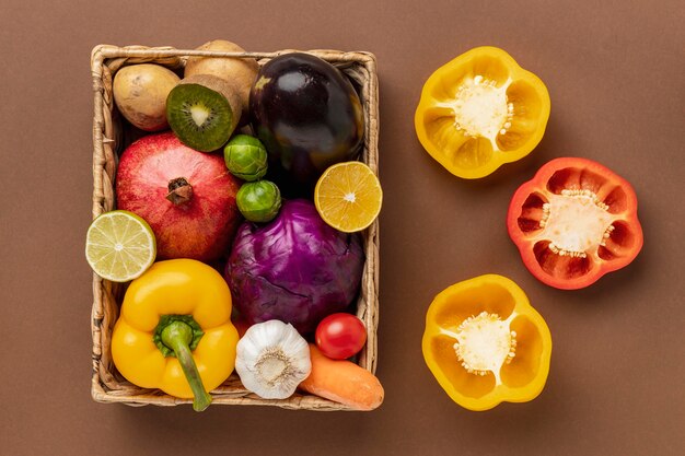 Flat lat of bell peppers with basket of vegetables