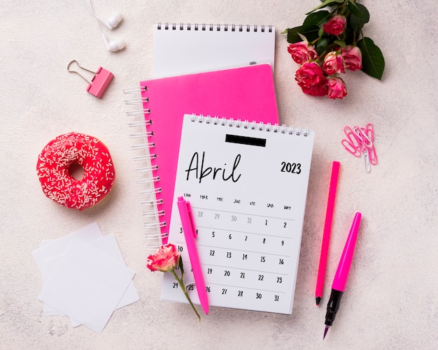 Free photo flat lay 2023 april calendar with doughnut