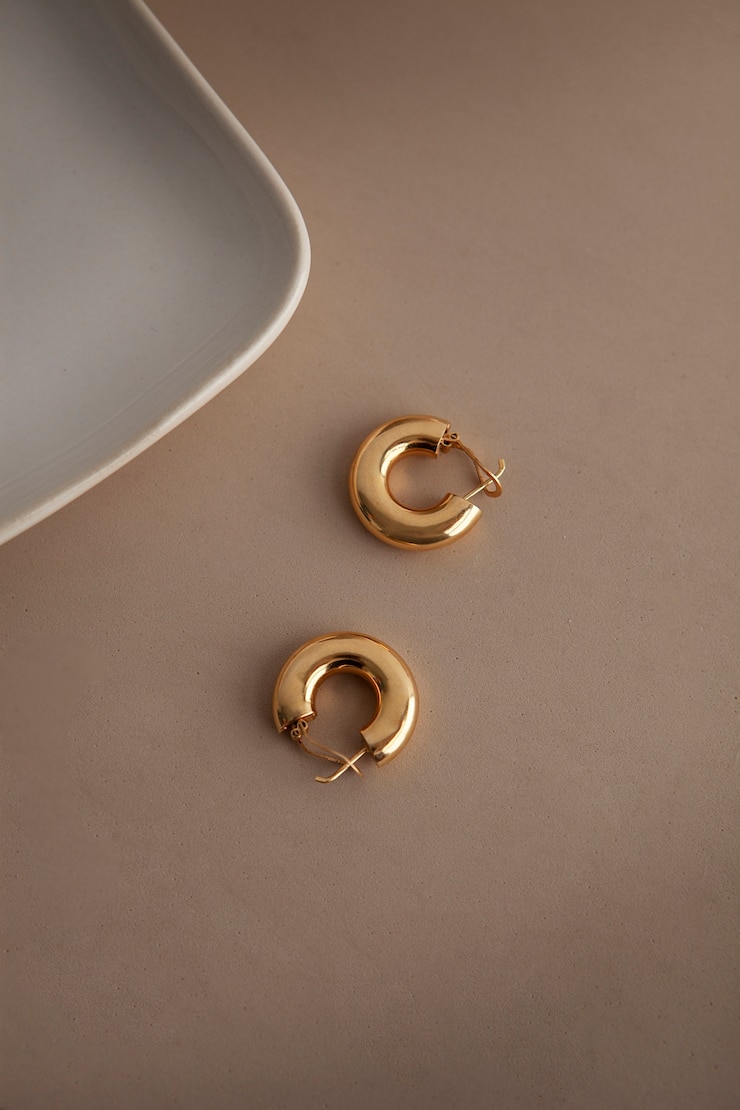 Free Photo flat lay aesthetic golden earrings arrangement