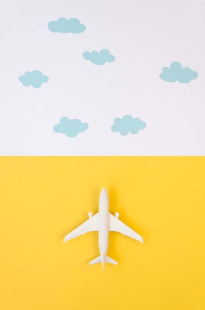 Flat lay airplane toy with clouds